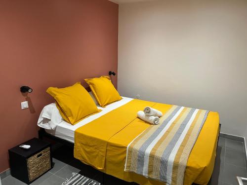 a stuffed teddy bear sitting on a bed at Ti kaz belair in Le Diamant