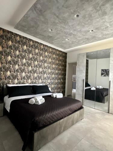 a bedroom with a large bed with towels on it at U Zu Ciccio in Terrasini