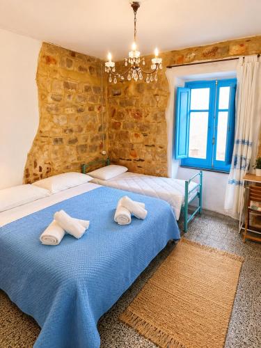 a bedroom with two beds and a brick wall at Paradice in Baunei in Baunei