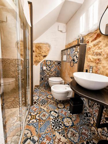 a bathroom with two toilets and a sink at Paradice in Baunei in Baunei