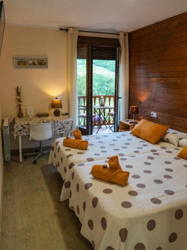 a bedroom with two beds with teddy bears on them at Alojamiento Rural Cosorios in Cangas de Onís