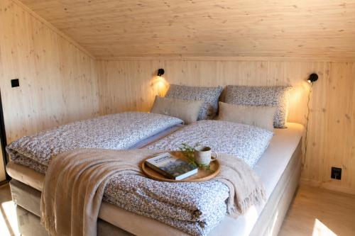 a bedroom with a bed with a tray on it at Chalet Glåpen in Moskenes