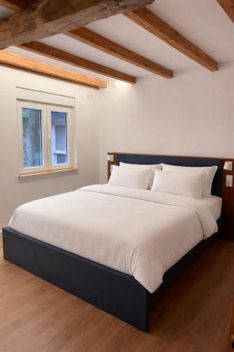 a bedroom with a large bed with white sheets at Alcacer 4 - 2 in Puentedeume