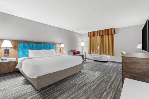 a hotel room with a bed and a television at Hampton Inn Guntersville in Guntersville