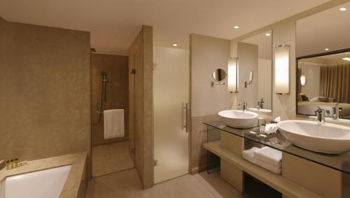 a bathroom with two sinks and a shower at DoubleTree by Hilton Agra in Agra