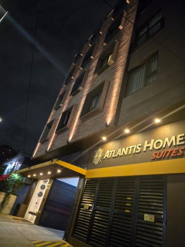 a building with an atantis home services sign on it at Atlantis Home Suites Zona T in Bogotá