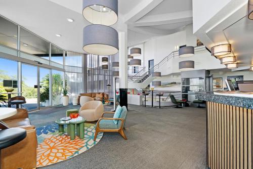an office with a lobby with chairs and tables at BEST WESTERN PLUS Apollo Hotel Newcastle in Newcastle