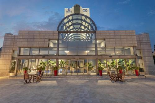 a large building with chairs in front of it at Ankara HiltonSA in Ankara