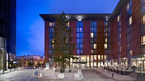 a christmas tree in front of a building at Hilton Garden Inn Birmingham Brindley Place in Birmingham