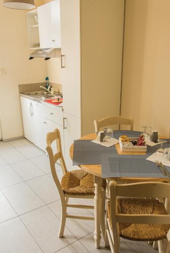 a kitchen with a table and two chairs and a table and a kitchen at Hotel Saint Georges in Mons