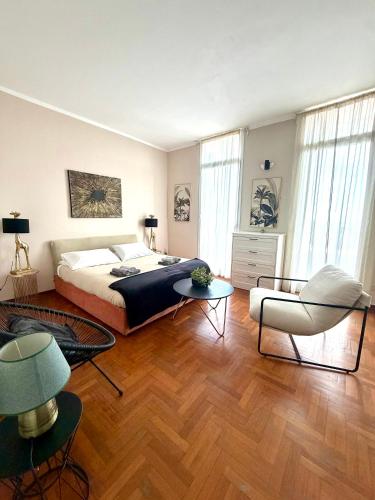 a bedroom with a bed and a table and a chair at Casa Della Baia With a beautiful view in Varazze