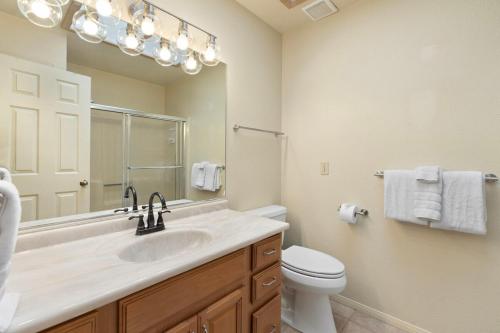 a bathroom with a sink and a toilet and a mirror at Sedona 2BR Near Trails & Shops in Sedona