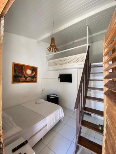 a bedroom with a bed and a staircase in it at Pousada Zayon Jeri in Jericoacoara