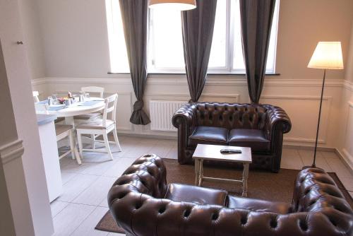 a living room with a couch and a table at Hotel Saint Georges in Mons
