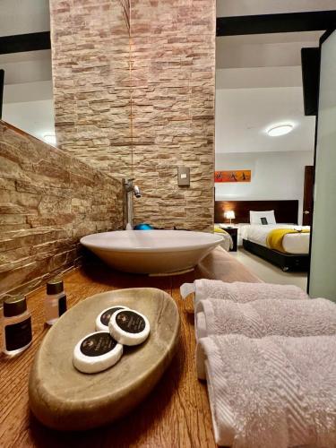 a bathroom with a tub and a sink in a room at PisonayMapiHotelBoutique in Machu Picchu