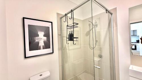 a bathroom with a shower with a glass door at Binshaw Main House in Glenlee Station