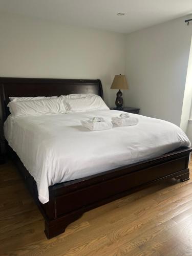 a bedroom with a large bed with white sheets at Boston Historic Lower Mills in Boston