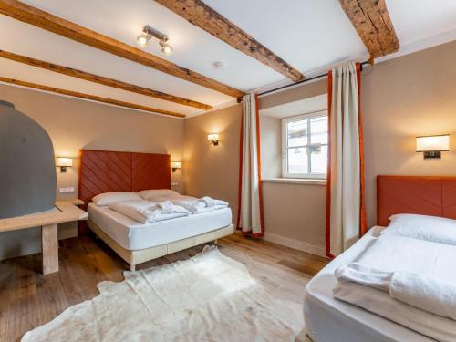 a bedroom with two beds and a window at Biber Art Apartment 2 Small in Biberwier
