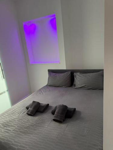 a bed with two pillows on it in a room at Stylish 1BR Apartment Close to City Center Liège in Liège