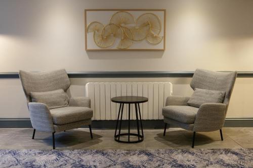 two chairs and a table in a waiting room at Hilton Cobham in Cobham