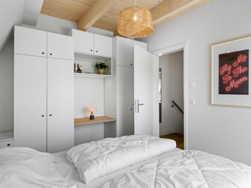 a bedroom with white cabinets and a bed at Schulzenhufe an der Ostsee in Beckerwitz