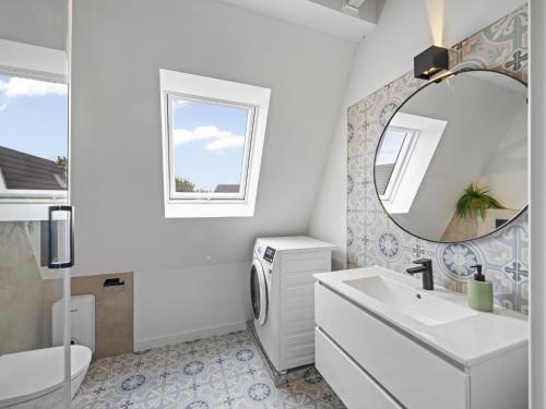 a white bathroom with a sink and a mirror at Schulzenhufe an der Ostsee in Beckerwitz