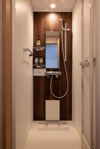 a bathroom with a shower and a mirror at House Of Joy Furano -15 mins to ski resort- in Furano