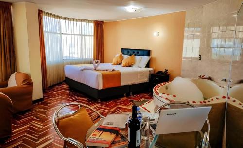 a hotel room with a bed and a desk with a laptop at Hotel San Lázaro Arequipa - Cochera - Hotel en Arequipa in Arequipa