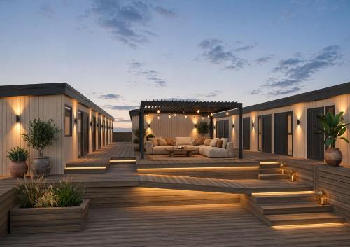 a deck with furniture and lights on it at Tauranga Backpackers - Private Guest Rooms by the Water! in Tauranga