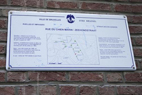 a sign hanging on a brick wall at B&B BE IN BRUSSELS in Brussels