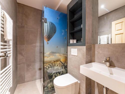 a bathroom with a shower with a toilet and a sink at Biber Art Apartment 2 Small in Biberwier