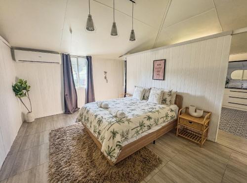 a bedroom with a large bed with a rug at Panacea Rising in Yeppoon