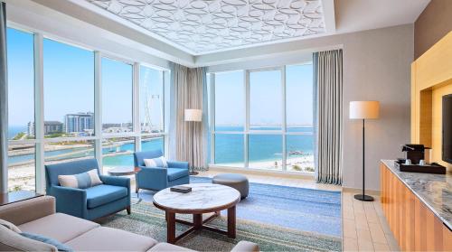 a living room with a view of the ocean at DoubleTree by Hilton Dubai Jumeirah Beach in Dubai