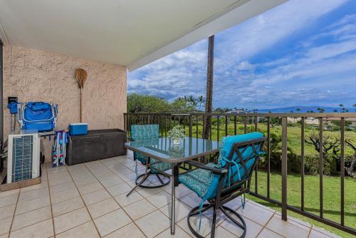 a patio with a table and chairs on a balcony at Kihei Alii Kai Ocean View Condo Pool, Hot Tub, Sauna, AC, Sleeps 4 in Kihei
