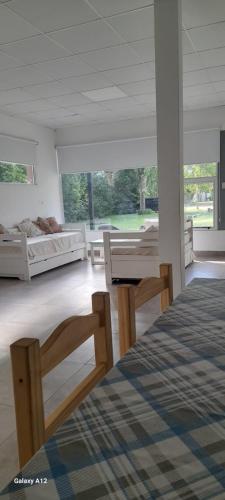a bedroom with two beds and a large window at QUINTA CERRO LARGO Olavarria in Olavarría