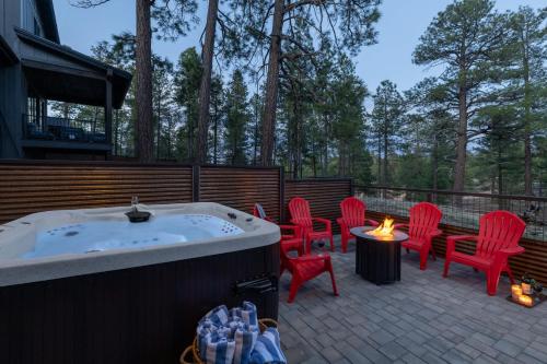 a hot tub on a patio with chairs and a table at Home with Studio near Pine Canyon in Flagstaff