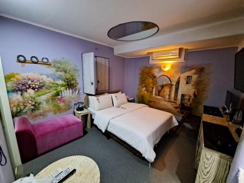 a bedroom with a bed and a tv and a couch at Amant Hotel in Goyang