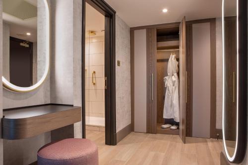 a bathroom with a walk in shower and a mirror at Hilton Glasgow in Glasgow
