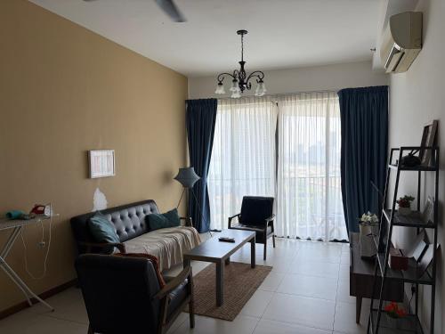 a living room with a couch and two chairs at The Landmark By Katana Penang in Tanjong Tokong