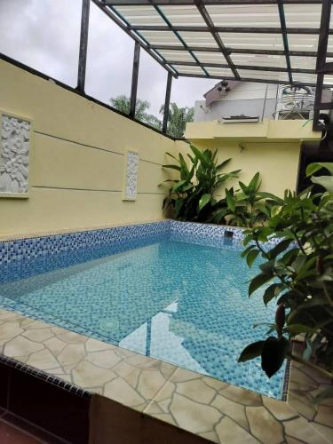 a swimming pool in the middle of a building at Dynz Cottage in Banting