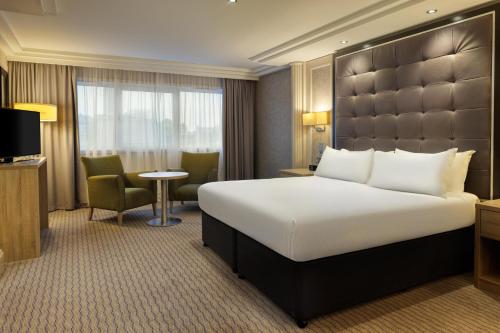 a hotel room with a large bed and a television at DoubleTree by Hilton Glasgow Central in Glasgow