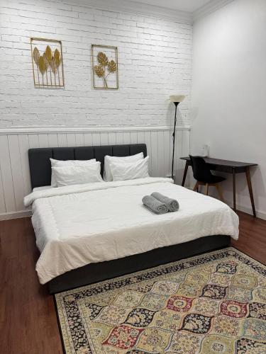 a bedroom with a large bed with a rug at Dynz Cottage in Banting