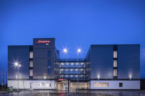 a building with a sign on the side of it at Hampton By Hilton Bristol Airport in Redhill