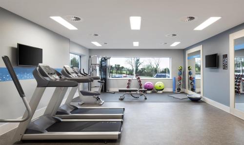 a gym with treadmills and elliptical machines at Hampton By Hilton Bristol Airport in Redhill