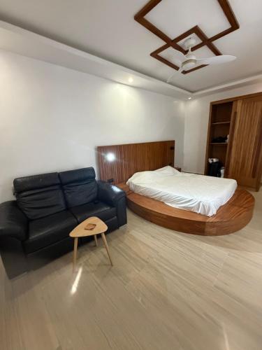 a living room with a bed and a couch at Ndiaghan Hébergement in CambÃ©rÃ¨ne