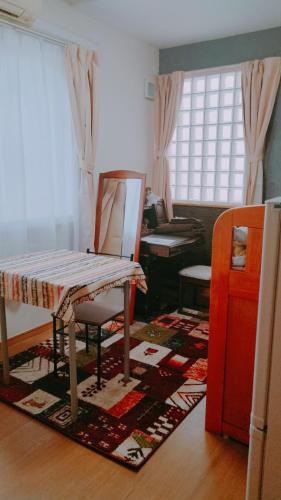 a living room with a mirror and a dressing table at Guest House Bamboo in Morioka