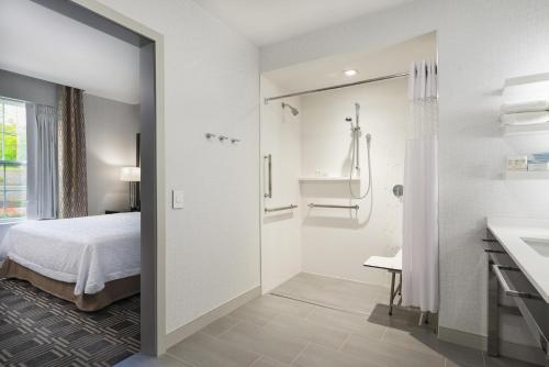 a bathroom with a bed and a shower at Hampton Inn & Suites Bridgewater, NJ in Bridgewater