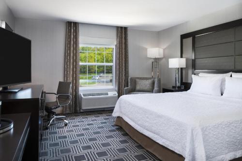 a hotel room with a bed and a window at Hampton Inn & Suites Bridgewater, NJ in Bridgewater