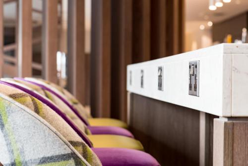 a row of chairs with purple and yellow at Hampton By Hilton Edinburgh West End in Edinburgh