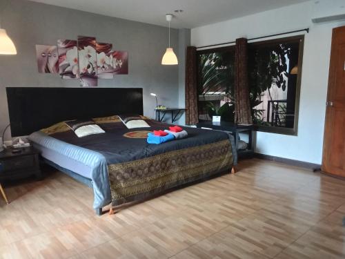a bedroom with a large bed with a blue blanket at Hi Karon Beach in Karon Beach